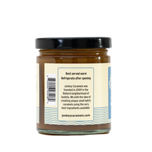 Load image into Gallery viewer, Side of view of caramel sauce jar with description of Jonboy Boy Caramel company info. &quot;Best served warm. Refrigerate after opening.&quot;
