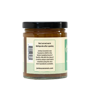 Side of view of vegan caramel sauce jar with description of Jonboy Boy Caramel company info. "Best served warm. Refrigerate after opening."